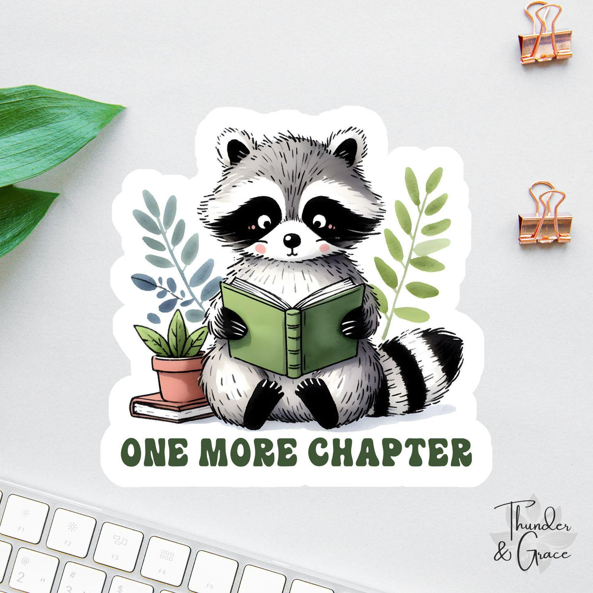 One More Chapter sticker, cute raccoon reading