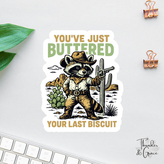 You've Just Buttered Your Last Biscuit sticker, cowboy raccoon